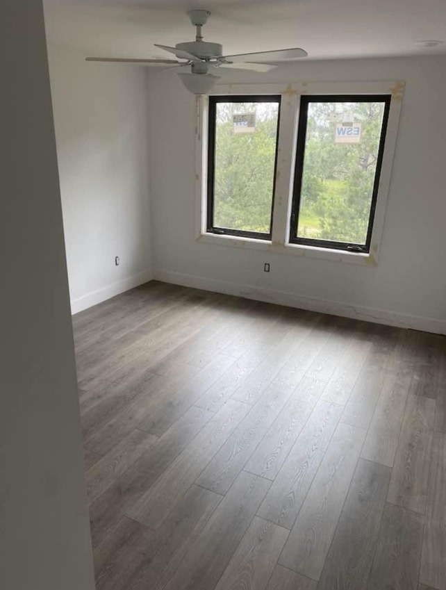 Bedroom with Laminate Flooring and Modern Windows