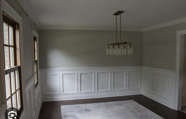 Dining Room with Wainscoting and Modern Chandelier