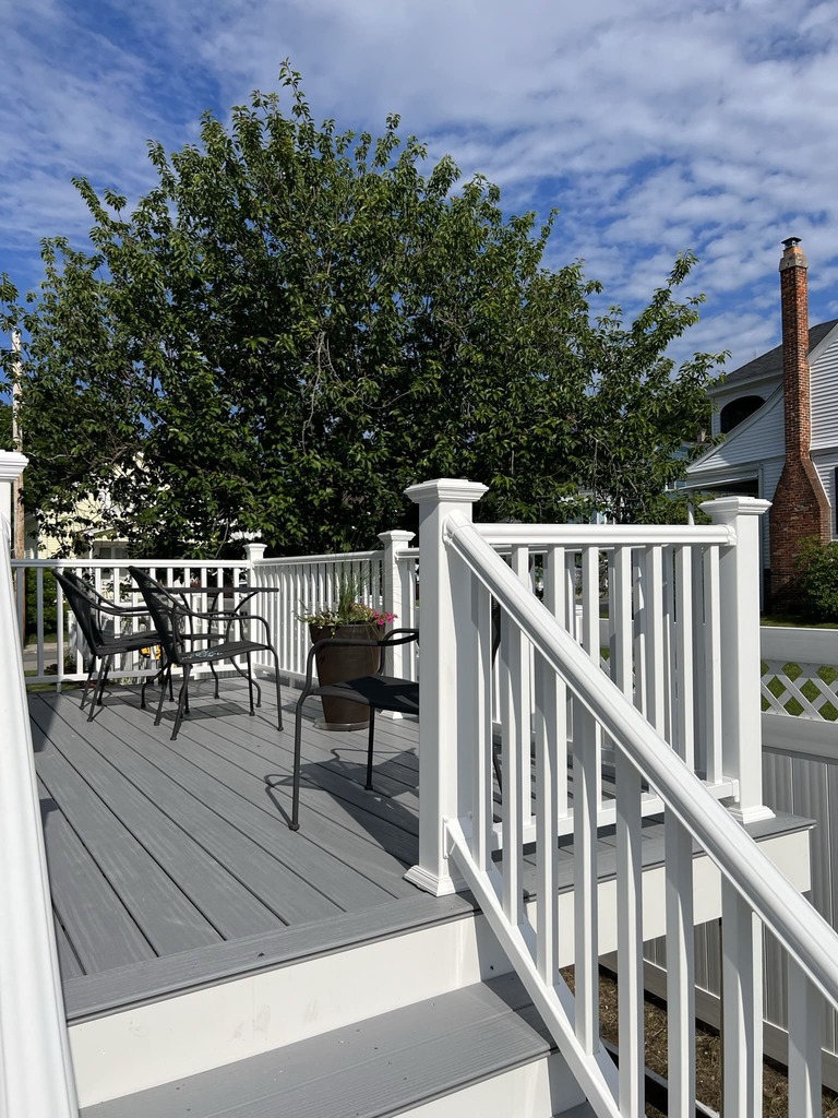 Finished Deck with White Railings and Seating Area