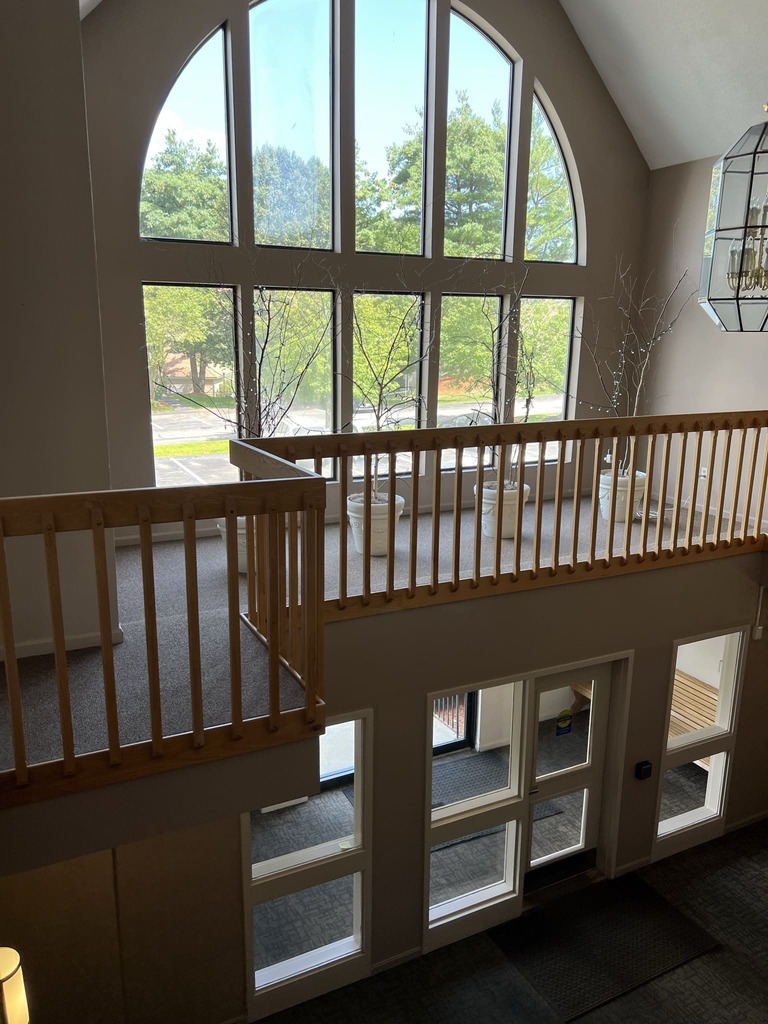 Loft Area with Arched Window and Wood Railings