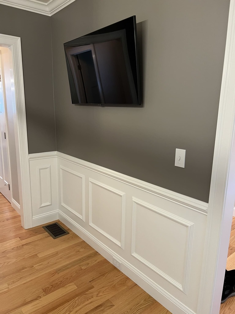 Elegant Wainscoting in Hallway with Mounted TV
