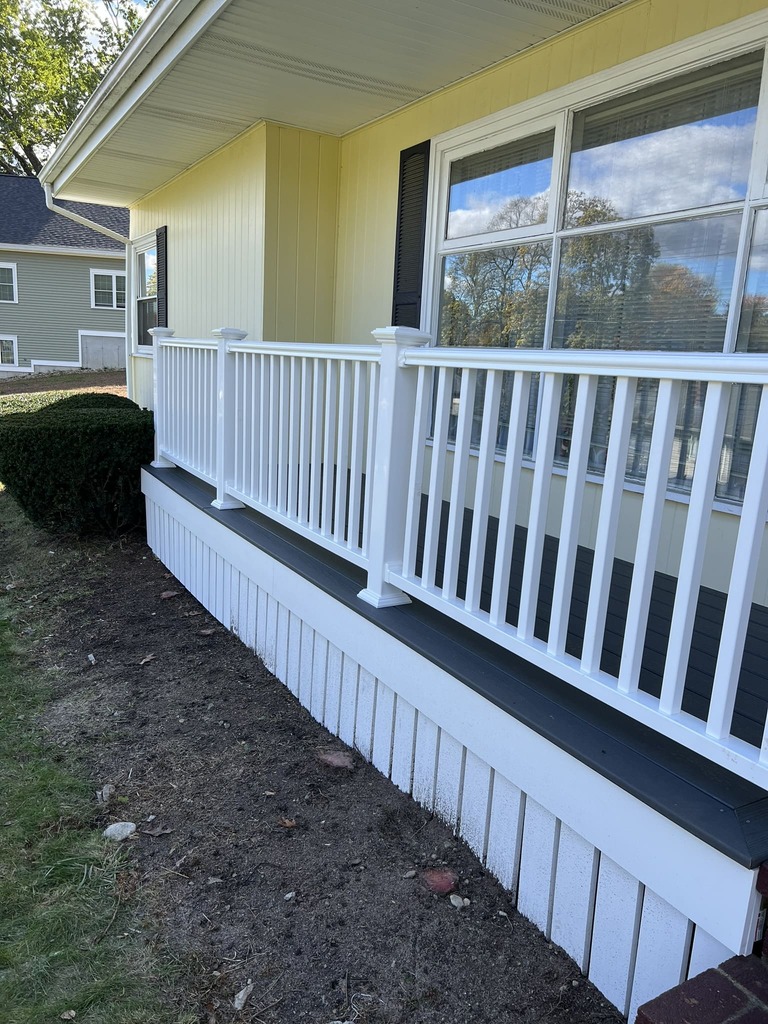 Front Porch with Yellow Siding and White Railings