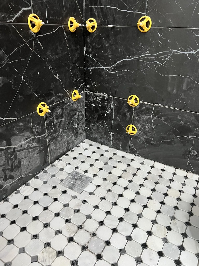 Classic Hexagonal Tile Floor with Black Marble Walls