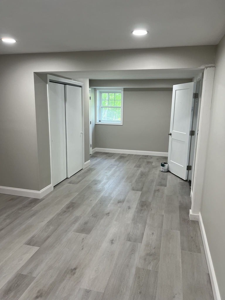 Finished Basement with Gray Flooring and Built-in Storage